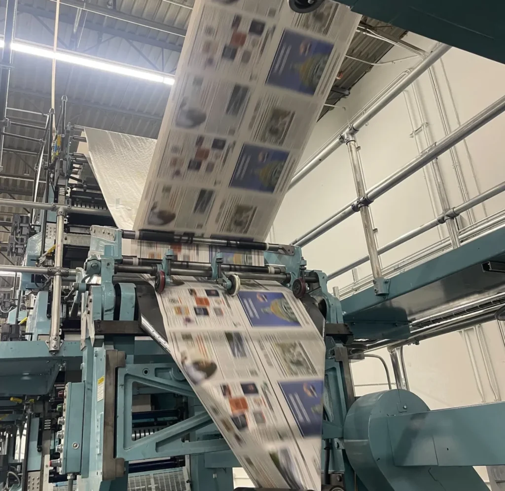 A printing press printing a newspaper